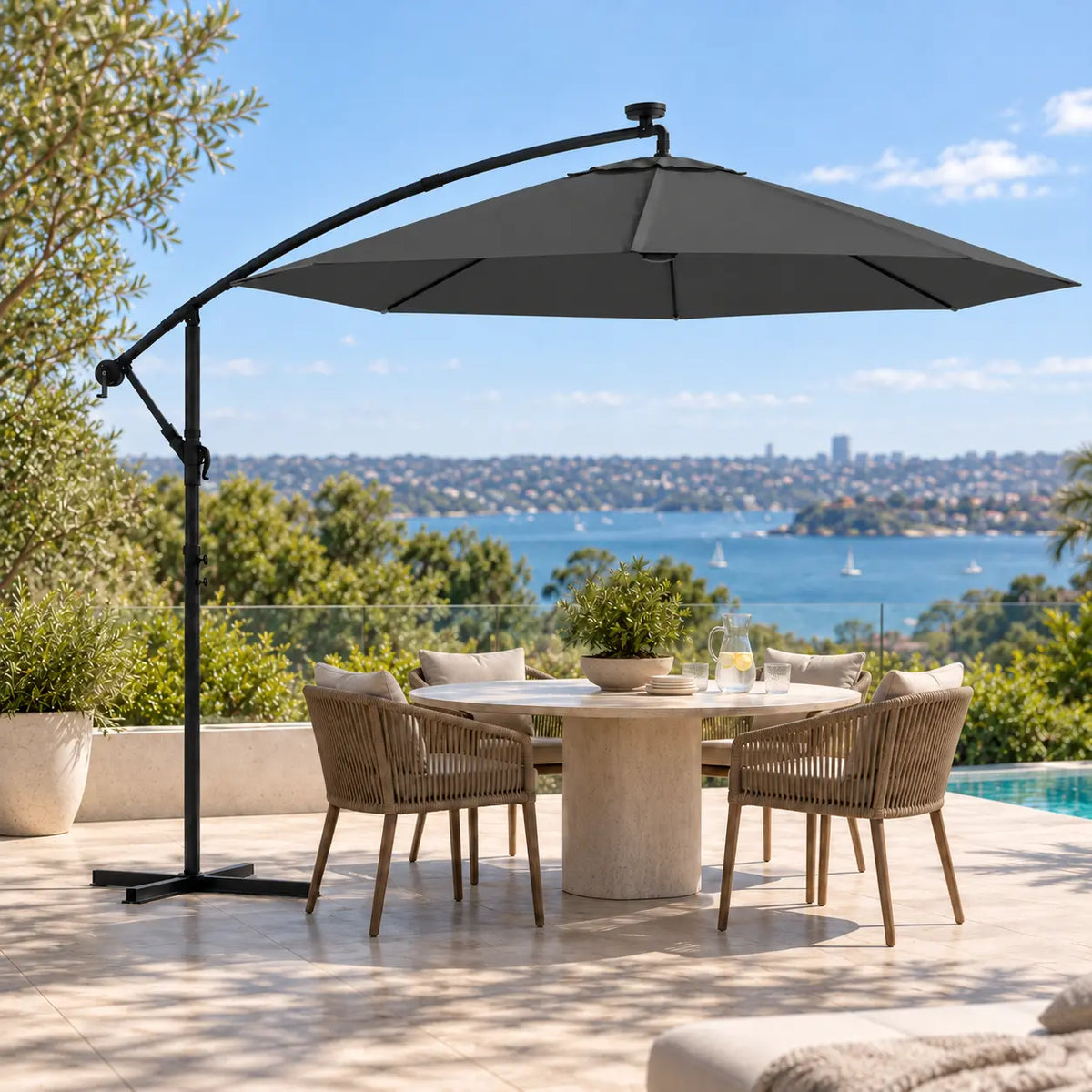 Round cantilever umbrella 3m anthracite solar LED over 5-seater round marble outdoor dining table poolside Sydney harbour view terrace