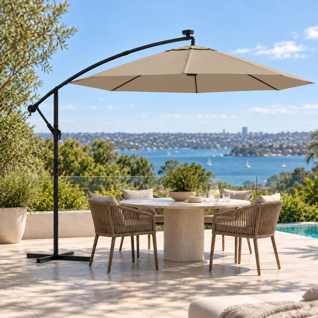 Round cantilever umbrella 3m taupe solar LED over 5-seater round marble outdoor dining table poolside Sydney harbour view terrace