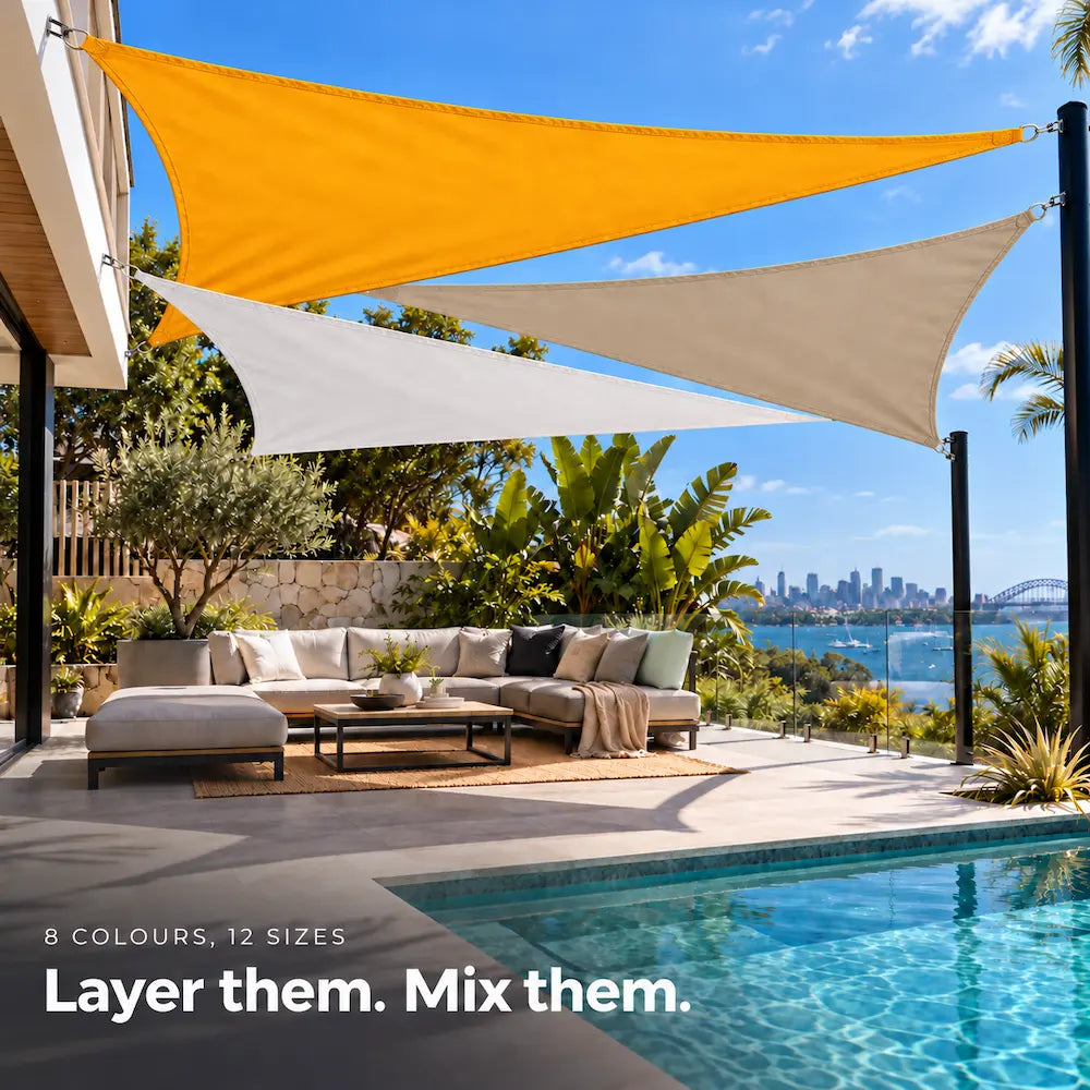 Shade sail mix of sunflower, white and sand triangles adding colour over a pool lounge area