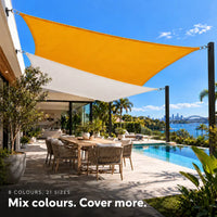 Shade sail in sunflower and white, two rectangular sails adding colour over a poolside dining area