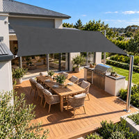 Shade sail charcoal rectangle over a timber deck with an outdoor kitchen and BBQ