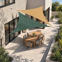 Shade sail forest green and sand triangles fixed to the house over a backyard dining table