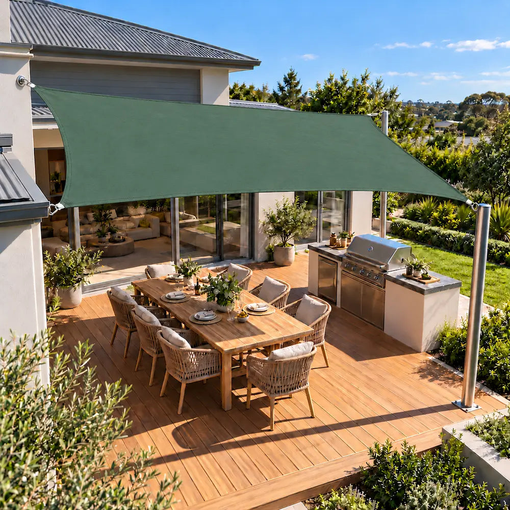 Shade sail forest green rectangle shading a backyard deck with an outdoor kitchen
