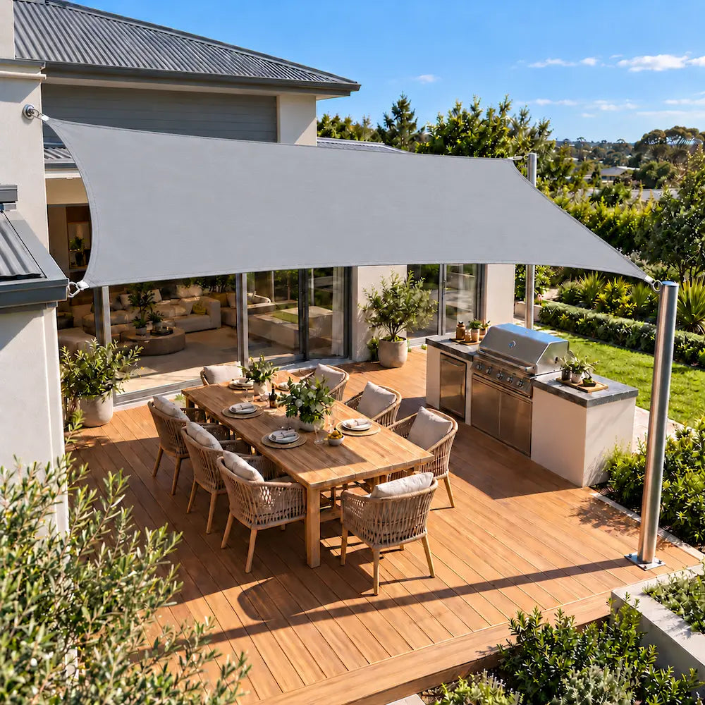 Shade sail light grey rectangle covering an entertaining deck and outdoor kitchen