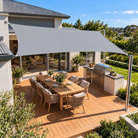Shade sail light grey rectangle covering an entertaining deck and outdoor kitchen