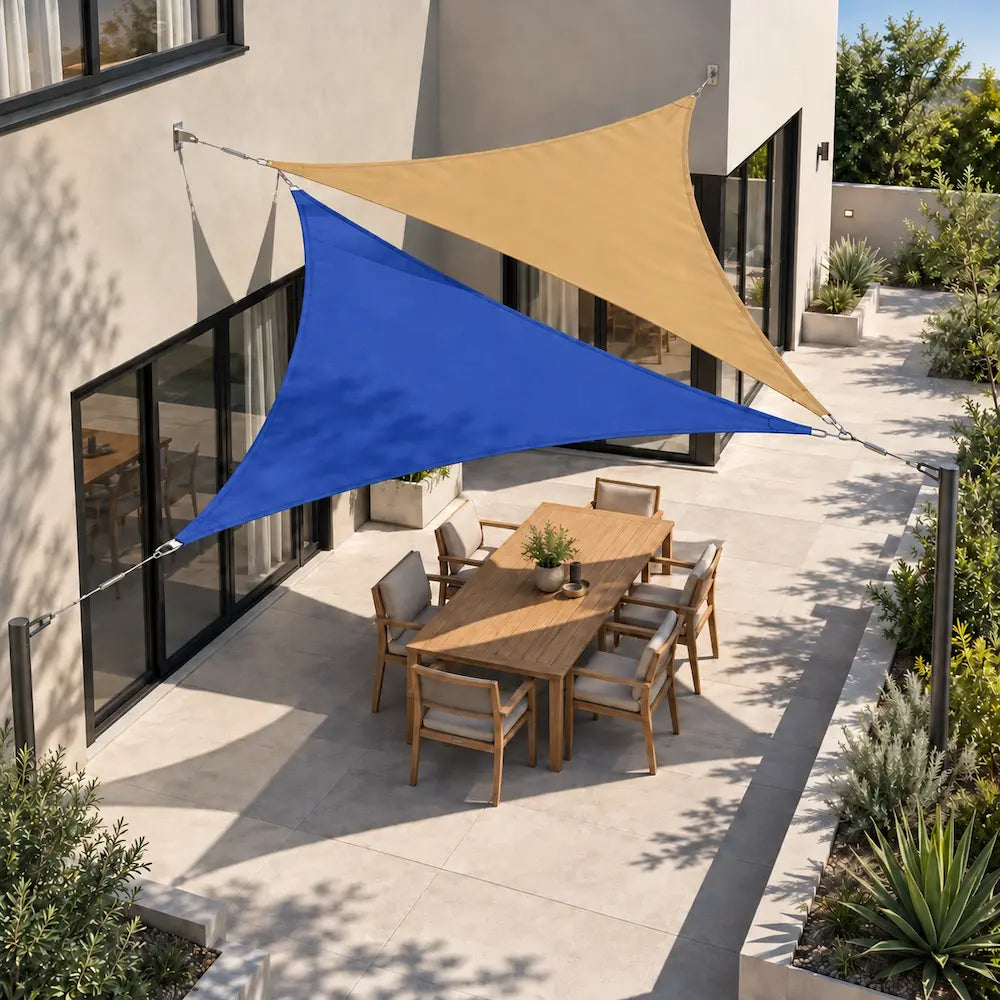 Shade sail ocean blue and sand triangles overlapping above a courtyard table, aerial view