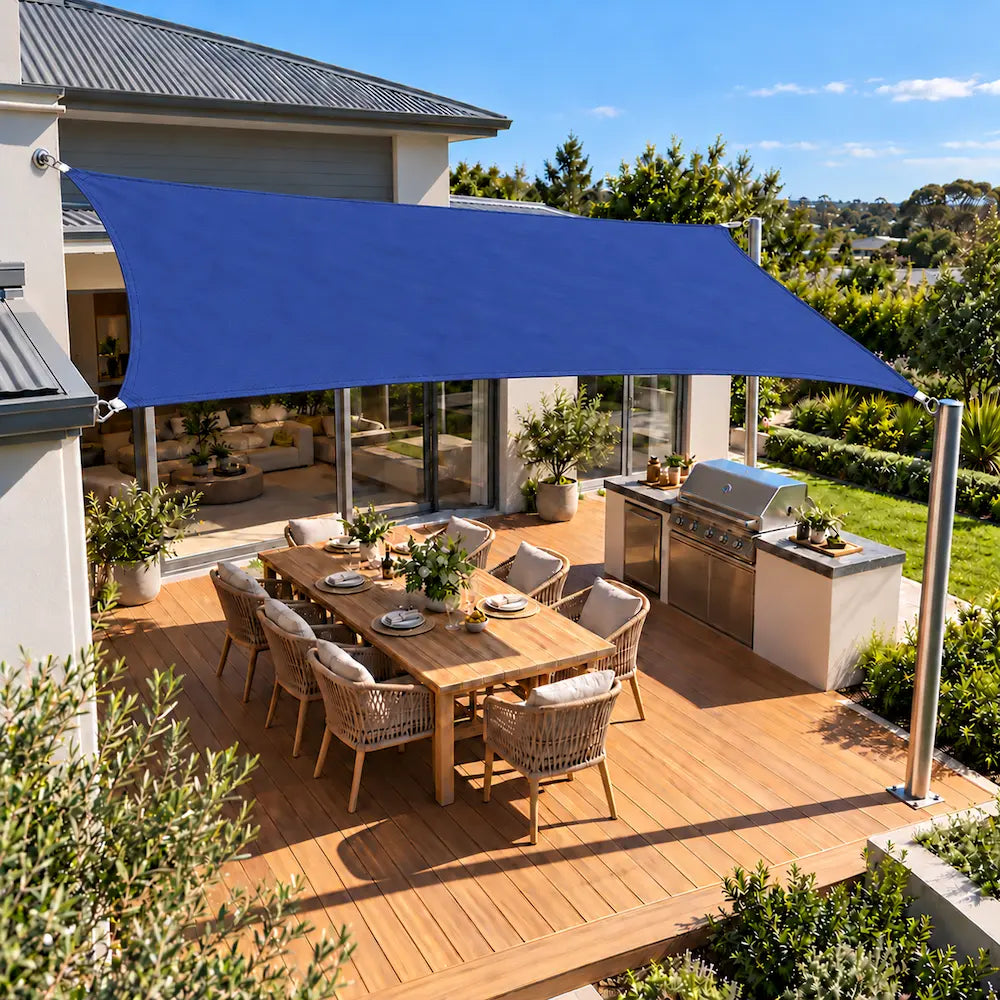 Shade sail ocean blue rectangle above a family deck with barbecue and dining setting