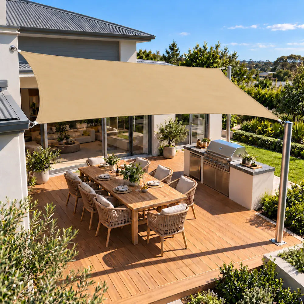 Shade sail sand rectangle shading an alfresco deck with built-in barbecue and dining table
