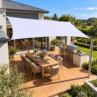 Shade sail white rectangle reflecting the heat above a timber deck and BBQ area