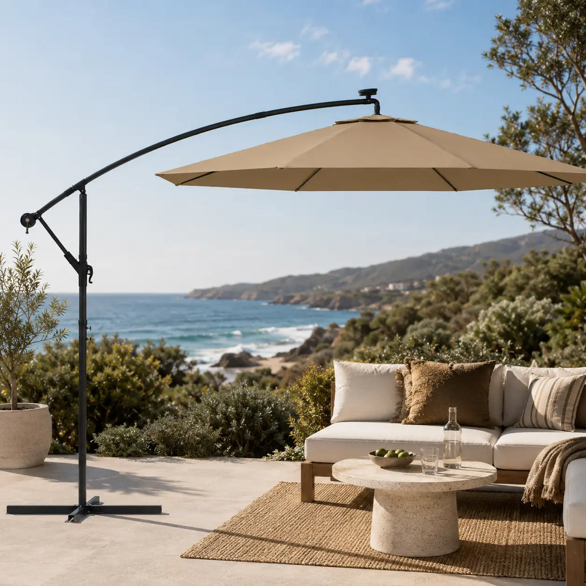 Round cantilever umbrella 3m Taupe over outdoor lounge set on open sea-view patio with jute rug – Meltem
