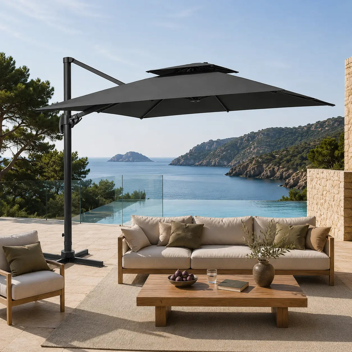 Anthracite cantilever umbrella providing shade over a teak outdoor lounge overlooking a coastal sea view and infinity pool