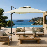 Ivory cantilever umbrella providing shade over a teak outdoor lounge setting overlooking a coastal sea view