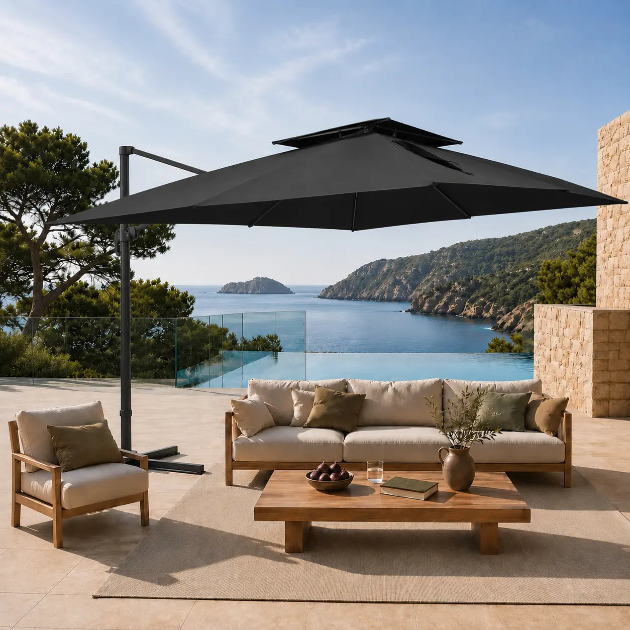 Black cantilever umbrella providing shade over a teak outdoor lounge setting on a poolside terrace overlooking a coastal bay