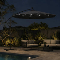 Round cantilever umbrella 3m Black with solar LED lights on over rope lounge set beside pool at night – Maestro