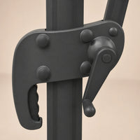 Close-up of the crank handle and locking mechanism on the Tramontane 3x3m cantilever umbrella in charcoal aluminium