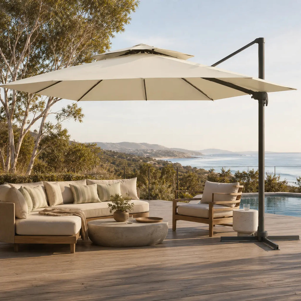 Ivory cantilever umbrella 3x4m with vented double canopy shading an outdoor lounge on a coastal timber deck