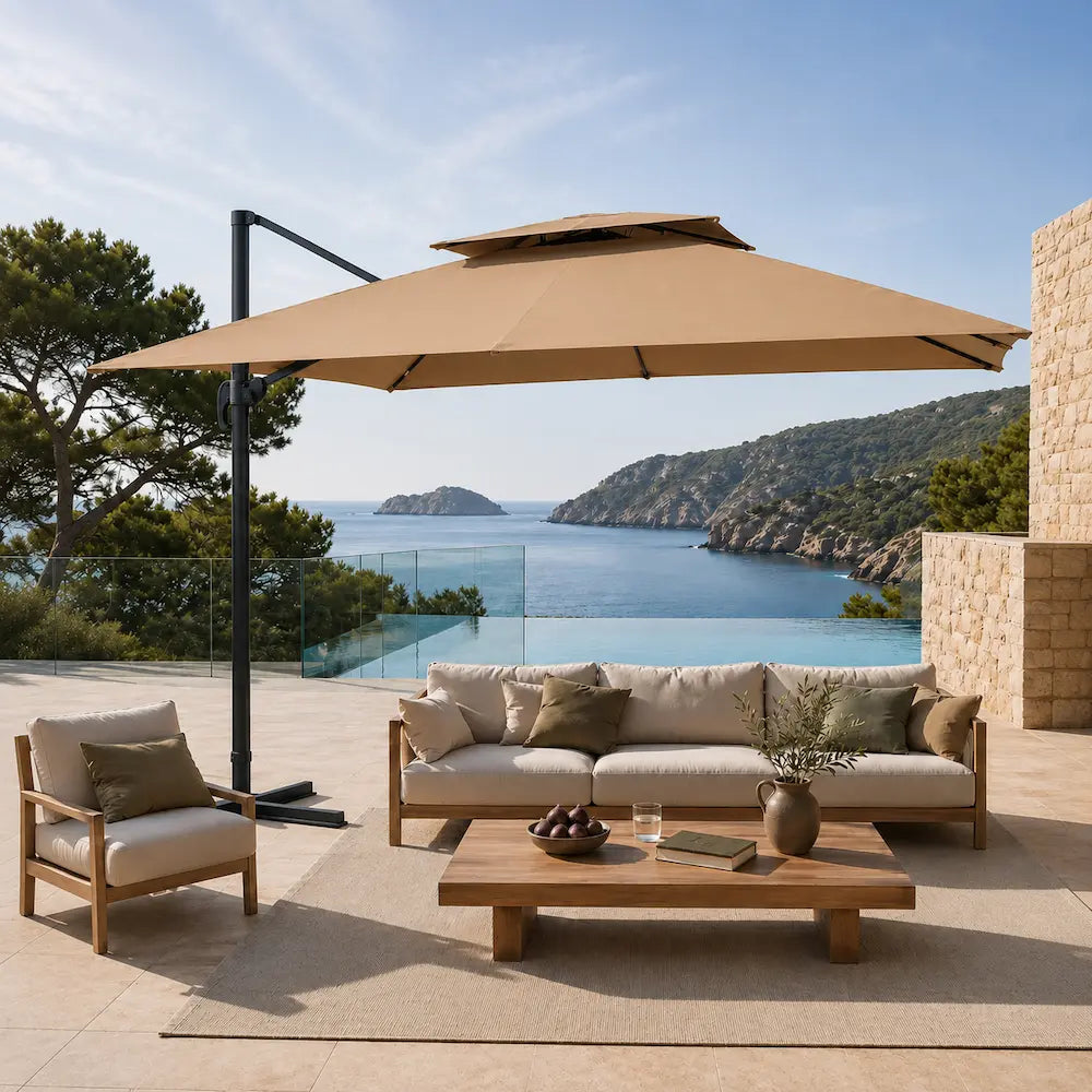 Taupe cantilever umbrella 3x3m with vented double canopy shading an outdoor lounge setting on a coastal terrace
