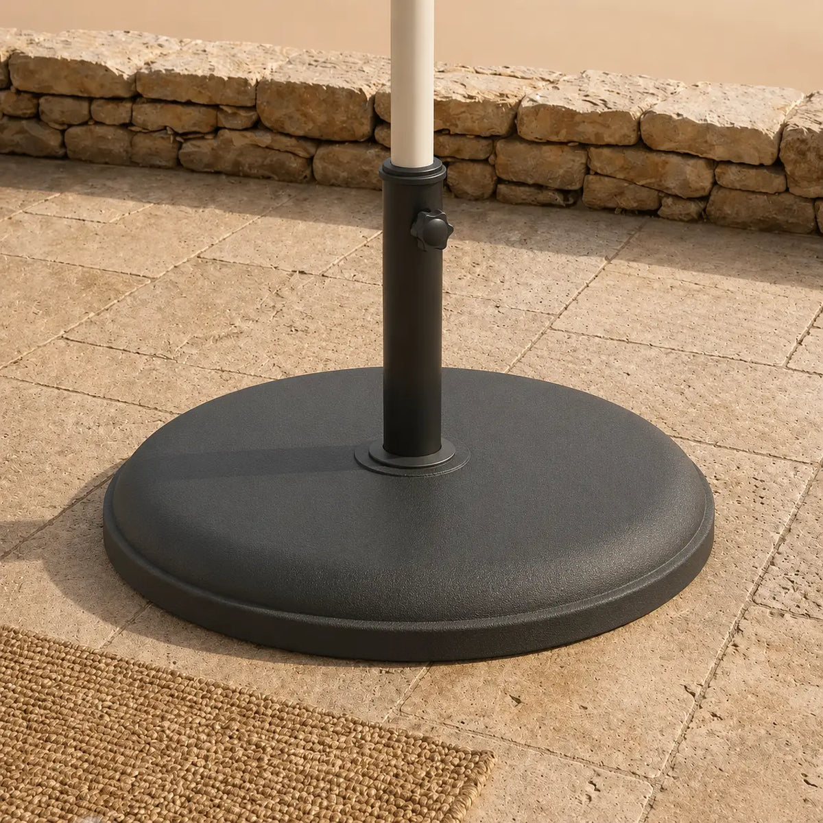 Round umbrella base installed on stone patio – 25kg anthracite weighted stand for patio umbrella, Australian outdoor setting