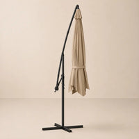 Round cantilever umbrella 3.5m Taupe folded and secured with carry strap on cross stand – Bora