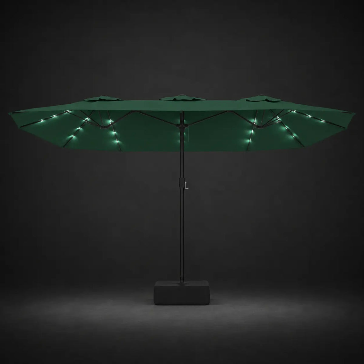 Green double canopy market umbrella with integrated LED lights illuminated at night on a dark background
