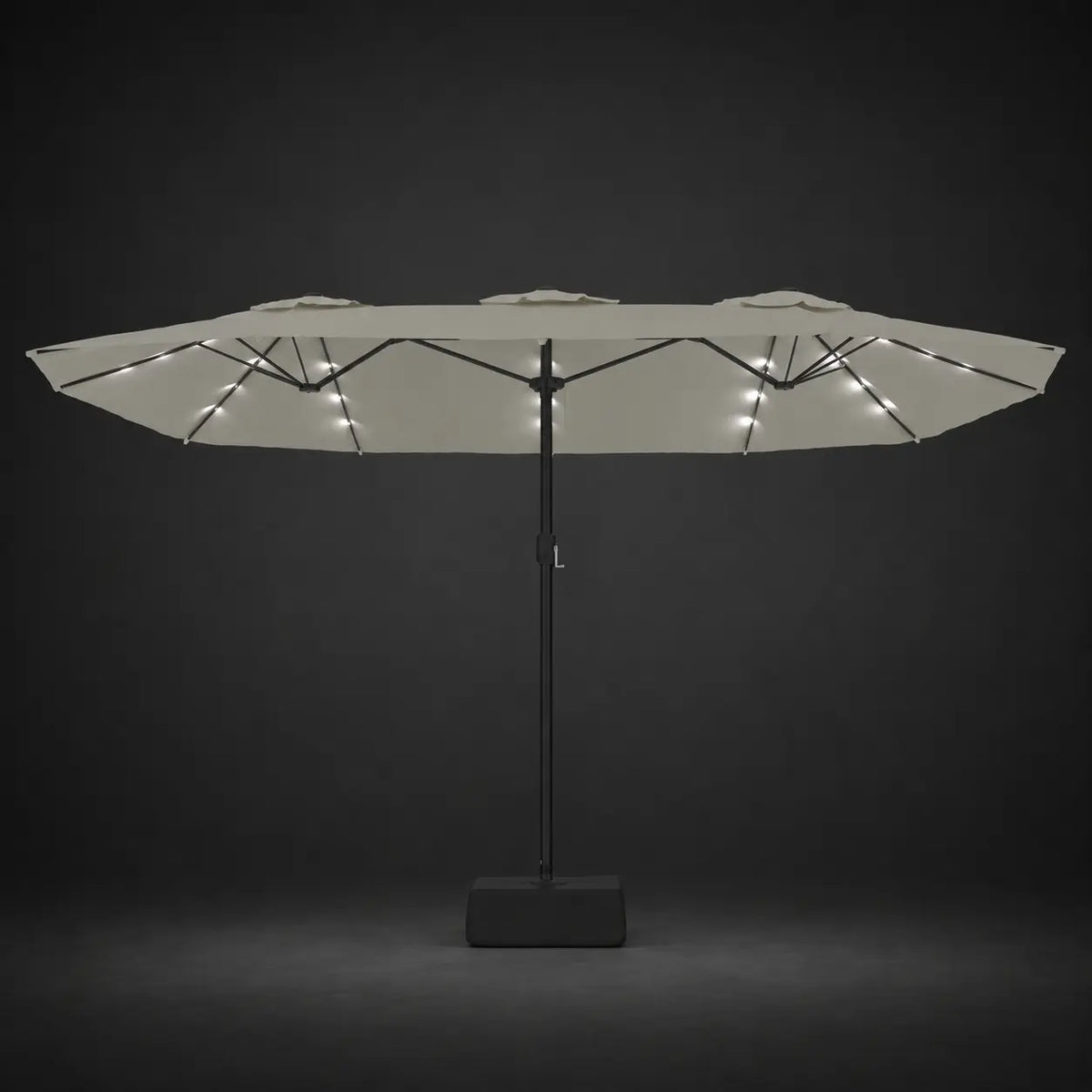 Sand white double canopy market umbrella with integrated LED lights illuminated at night on a dark background