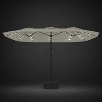 Sand white double canopy market umbrella with integrated LED lights illuminated at night on a dark background