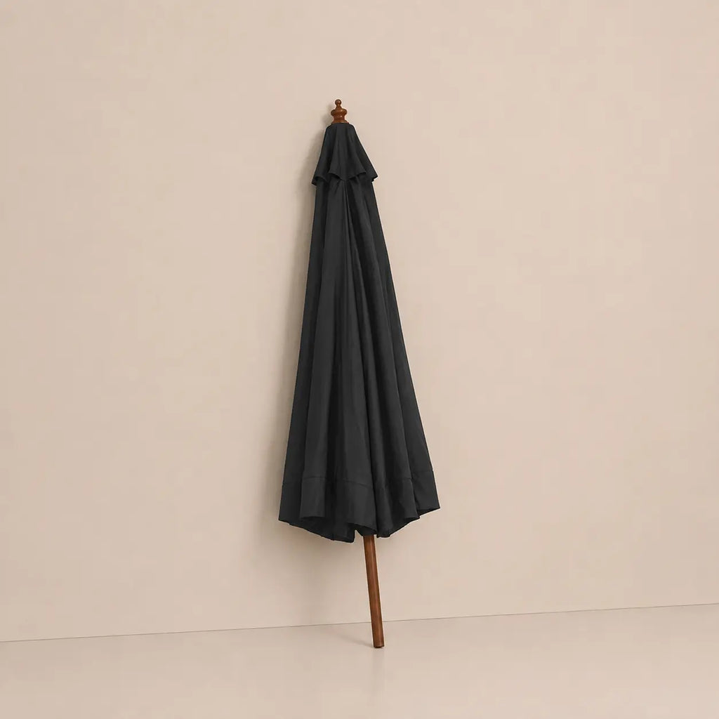 Anthracite market umbrella folded closed with hardwood pole and carved wooden finial