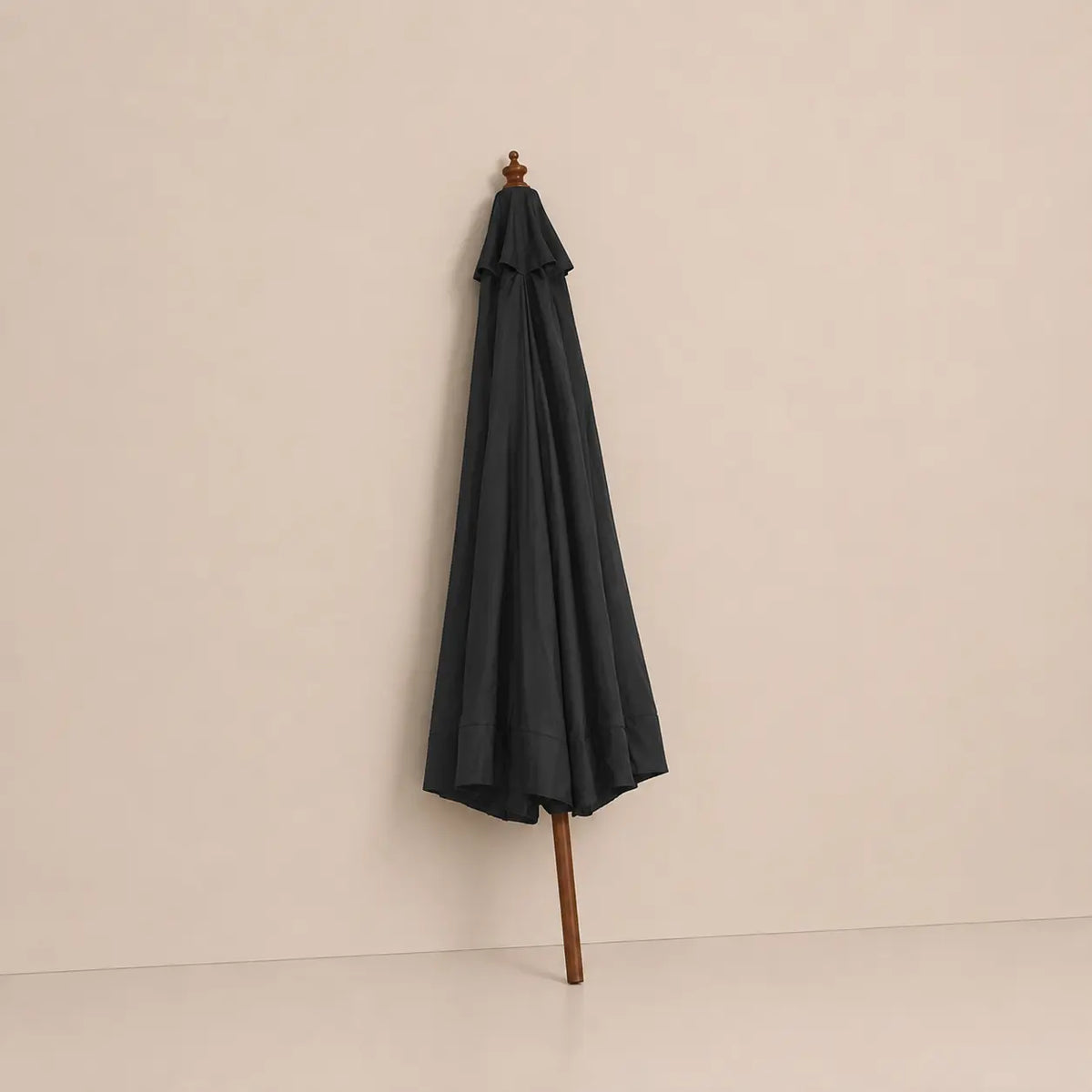 Anthracite market umbrella folded closed with hardwood pole and carved wooden finial