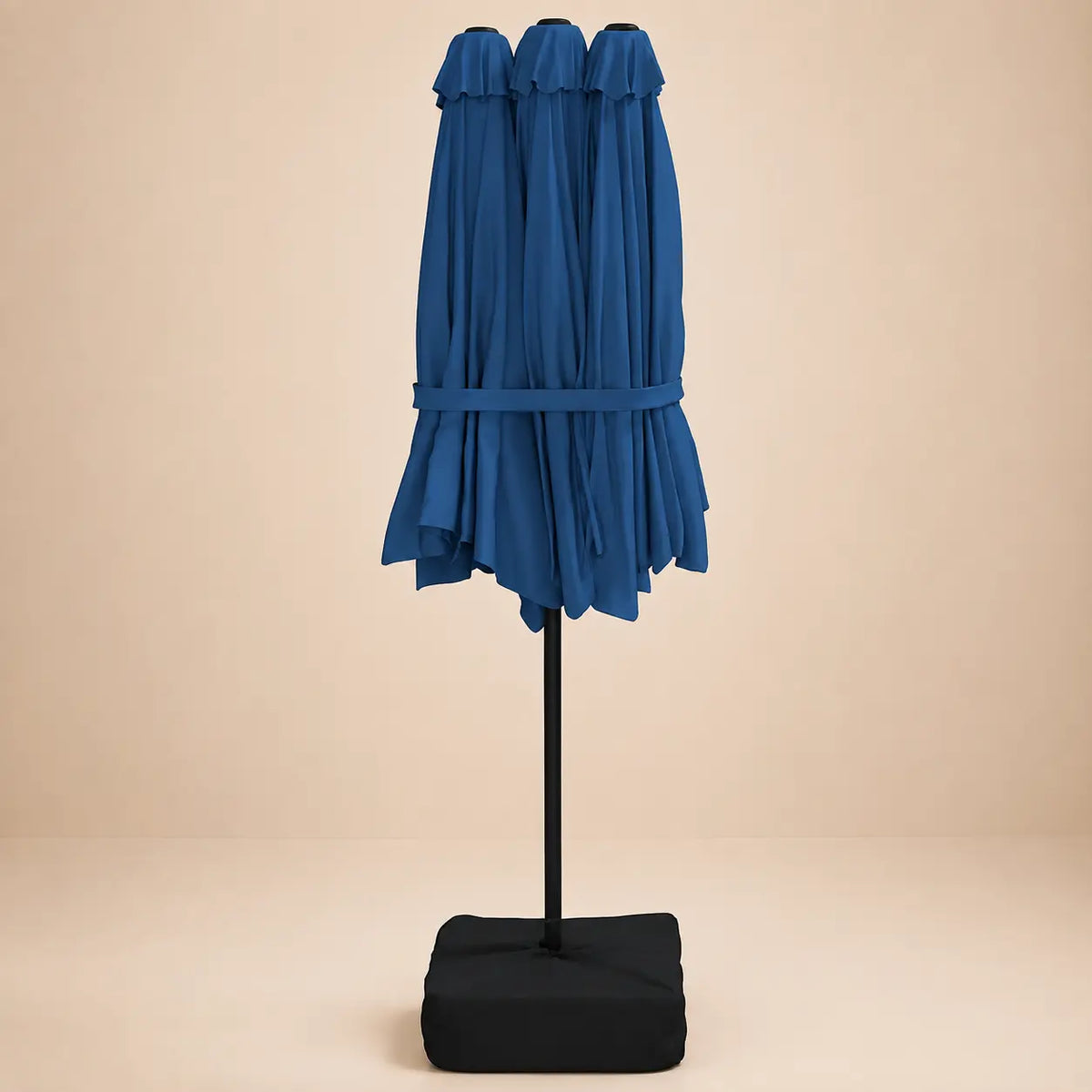 Azure blue double canopy market umbrella folded closed on black aluminium pole with square weighted base