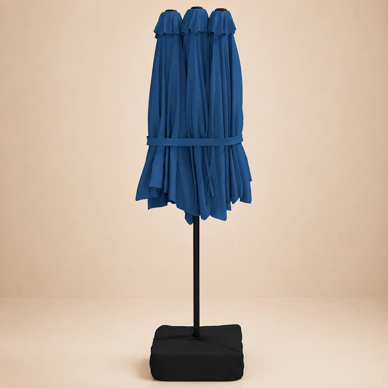 Azure blue double canopy market umbrella folded closed on black aluminium pole with square weighted base