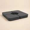 Cantilever umbrella base weight – 4-piece anthracite sand-fill plates assembled, top angled view, Holdfast 100kg stabiliser kit