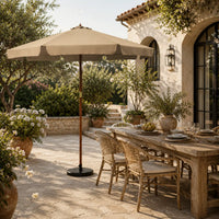 3.3m taupe market umbrella beside a timber outdoor dining table in a garden alfresco setting