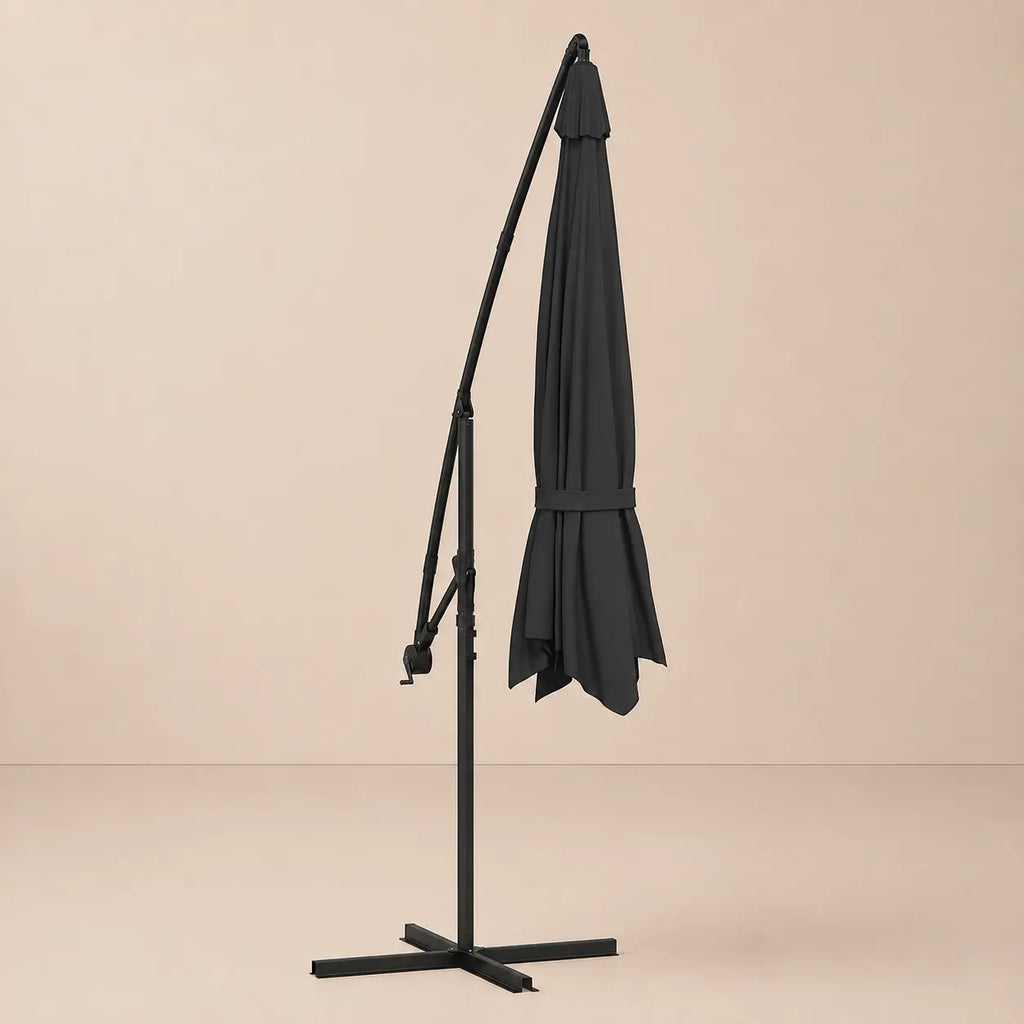 Round cantilever umbrella 3.5m Anthracite folded and secured with carry strap on cross stand – Gregal