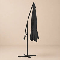 Round cantilever umbrella 3.5m Anthracite folded and secured with carry strap on cross stand – Gregal