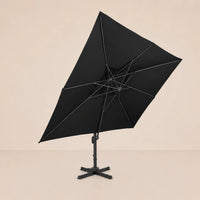 Underside view of the tilted rectangular cantilever umbrella showing the reinforced aluminium rib frame and black canopy