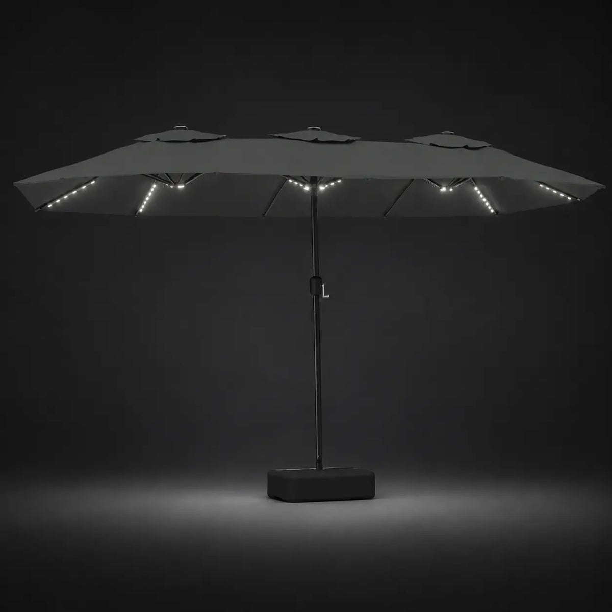 Anthracite double canopy market umbrella with integrated LED lights illuminated at night on a dark background