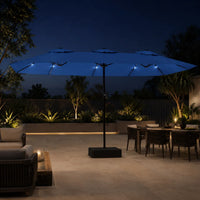 Large azure blue double canopy market umbrella with LED lights over an outdoor lounge and dining area at night