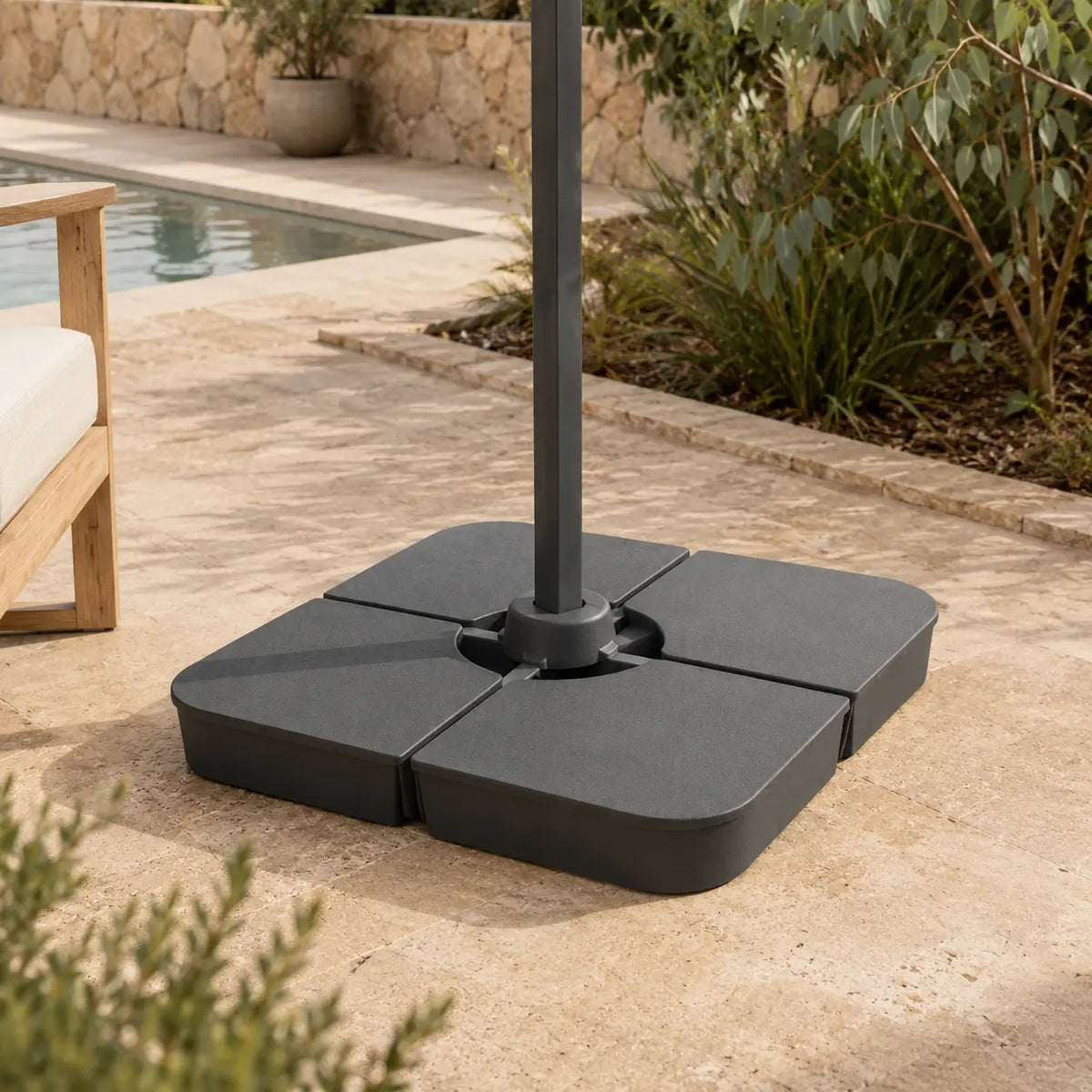 Cantilever umbrella base weight installed on poolside patio – 4-piece 100kg sand-fill anchor, dark grey, Australian backyard setting