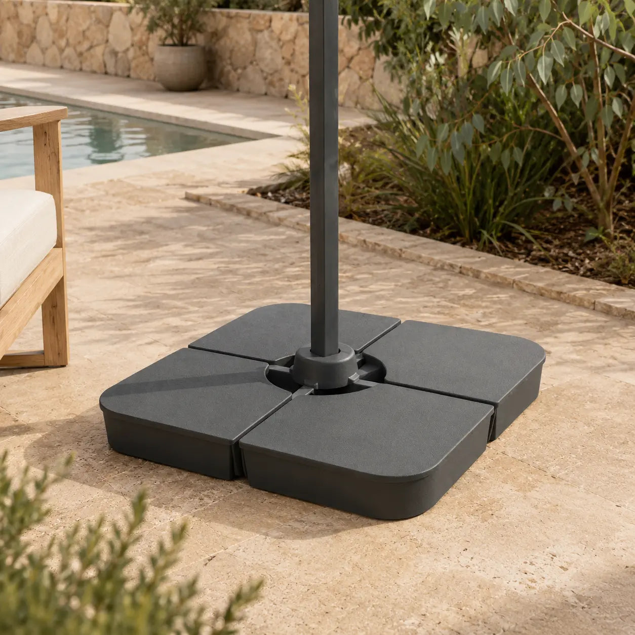 Cantilever umbrella base weight installed on poolside patio – 4-piece 100kg sand-fill anchor, dark grey, Australian backyard setting