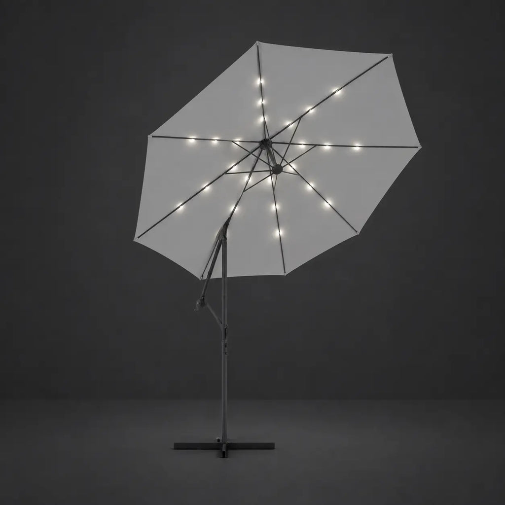 Round cantilever umbrella 3m Sand with solar LED lights illuminated along ribs at night – Solano