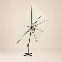 Underside view of the tilted square cantilever umbrella showing the reinforced aluminium rib frame and ivory canopy