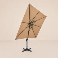 Underside view of the tilted 3x3m cantilever umbrella showing the eight-rib aluminium frame and taupe canopy