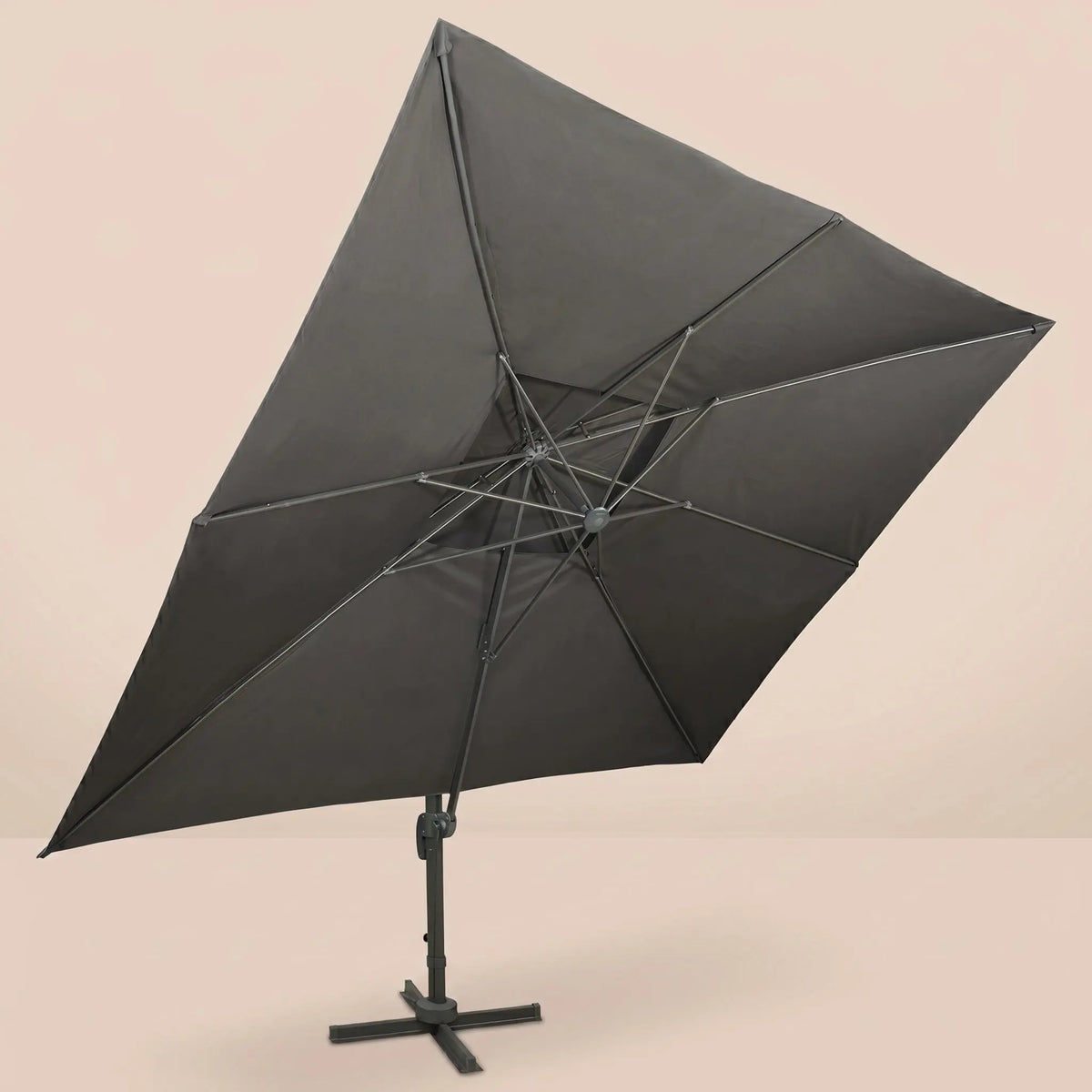 Underside view of the tilted rectangular cantilever umbrella showing the reinforced aluminium rib frame and anthracite canopy