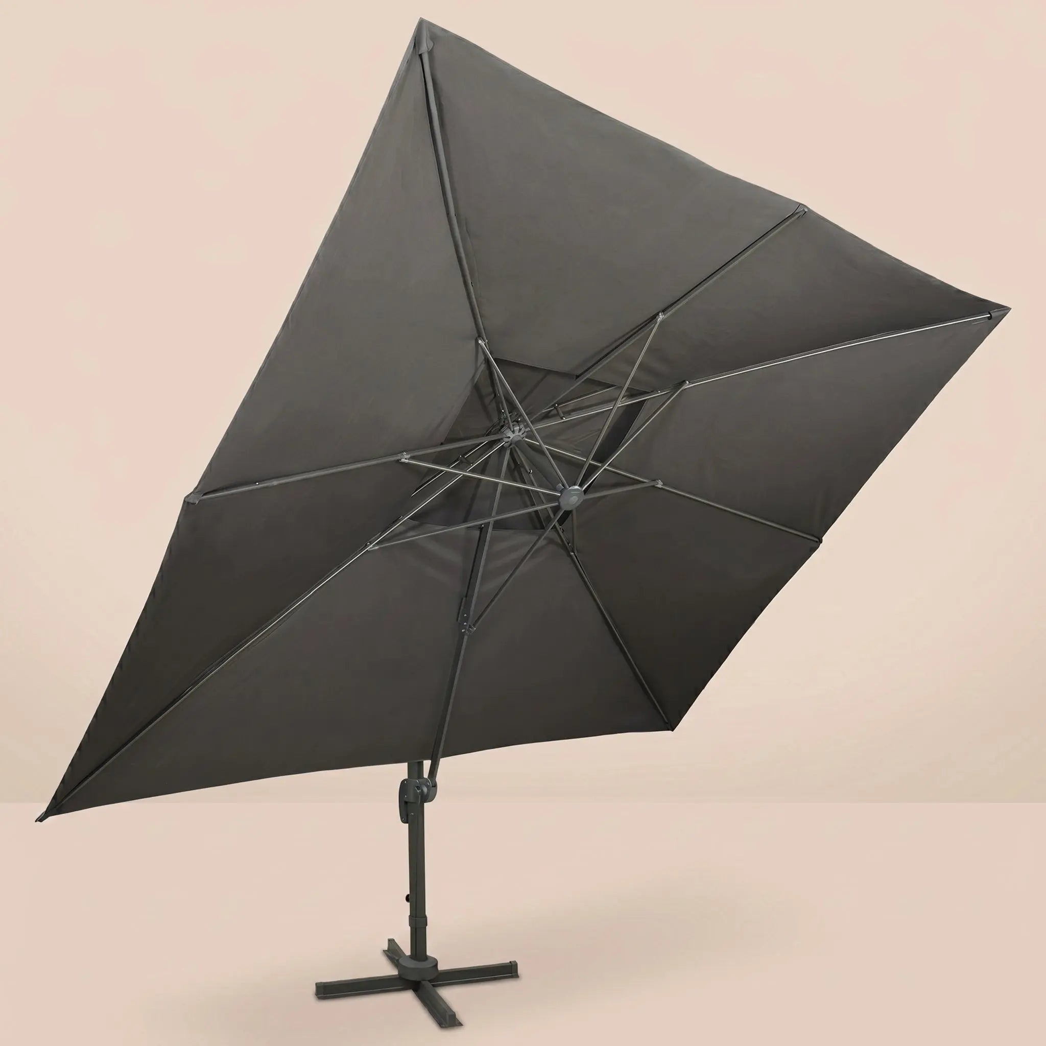 Underside view of the tilted rectangular cantilever umbrella showing the reinforced aluminium rib frame and anthracite canopy
