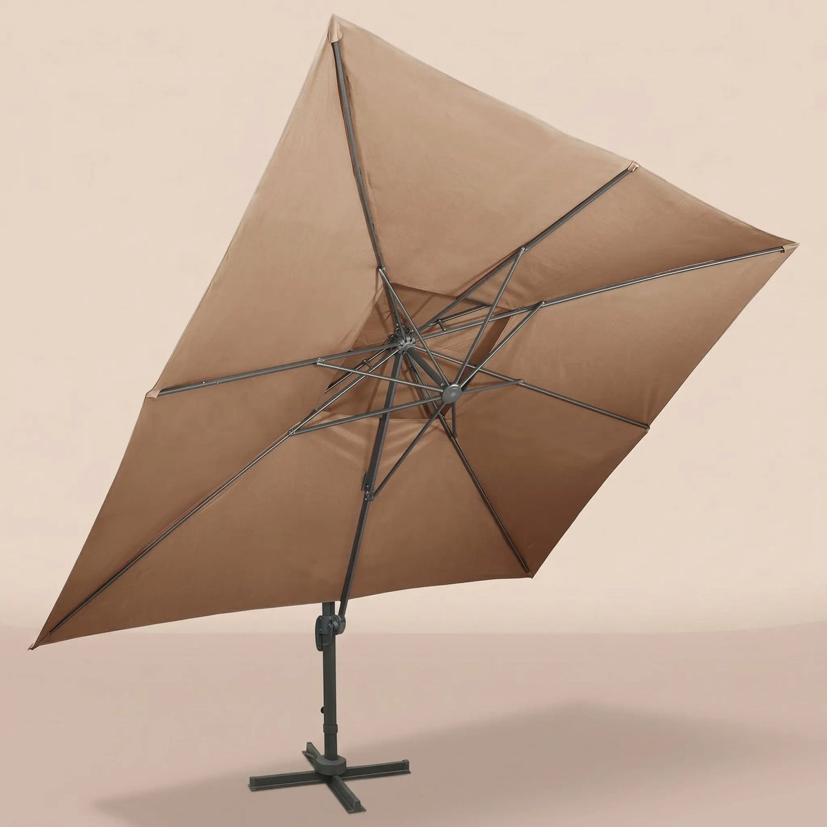 Underside view of the tilted rectangular cantilever umbrella showing the reinforced aluminium rib frame and taupe canopy