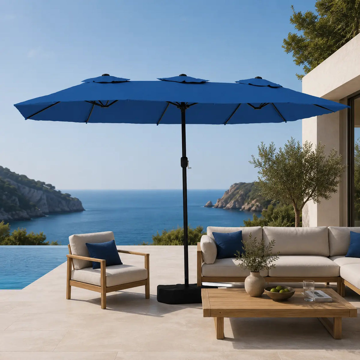 Large azure blue double canopy market umbrella over timber outdoor lounge furniture on a coastal Australian terrace