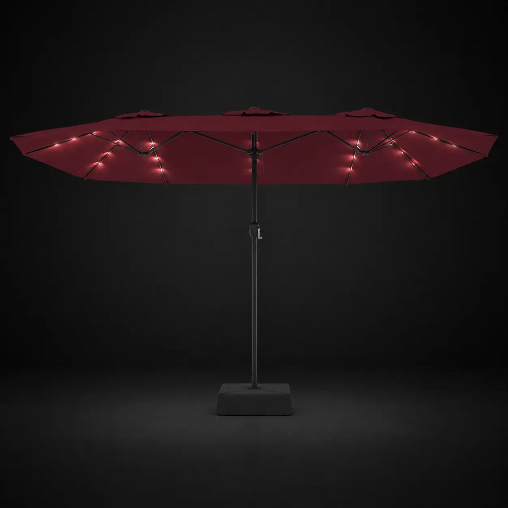 Bordeaux double canopy market umbrella with integrated LED lights illuminated at night on a dark background