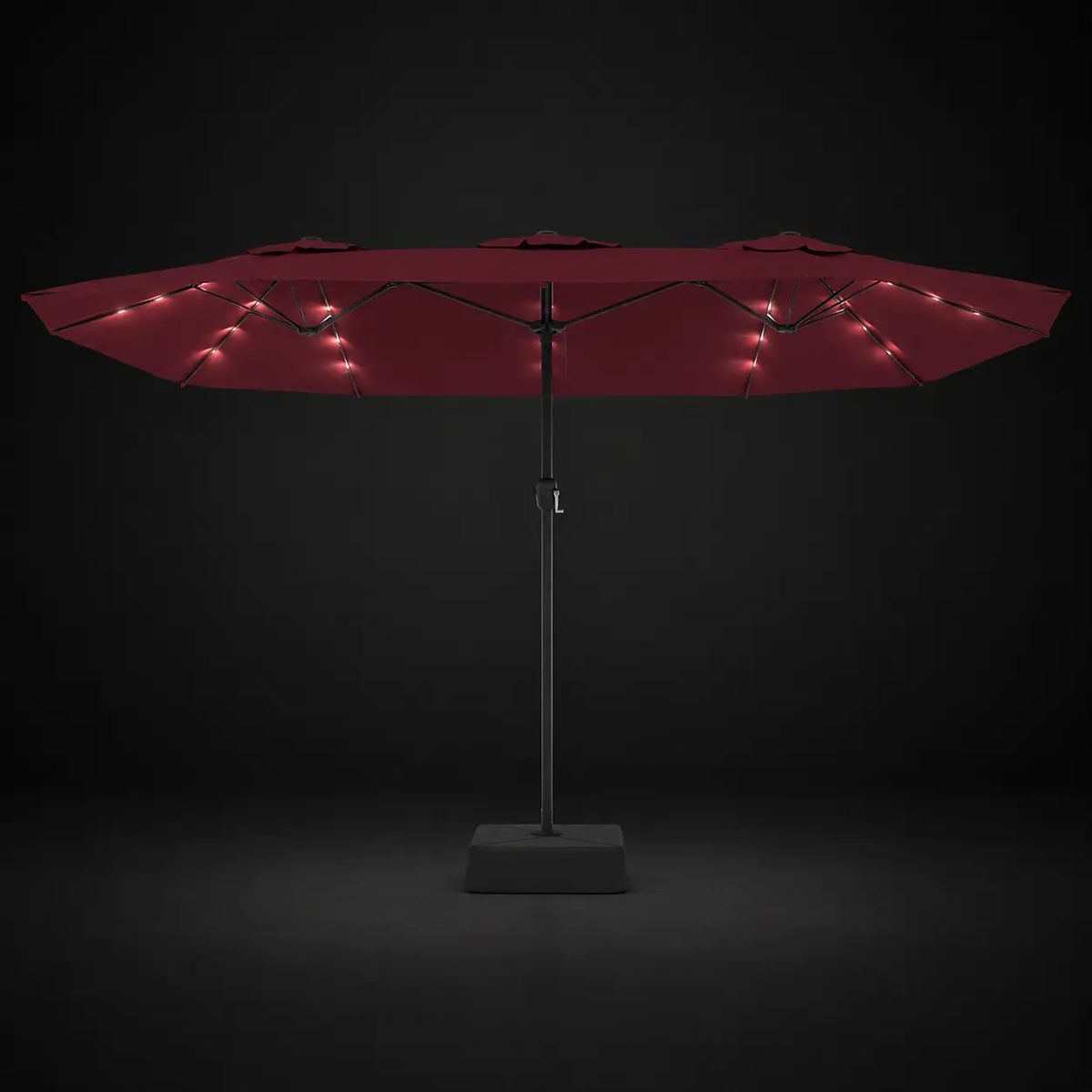 Bordeaux double canopy market umbrella with integrated LED lights illuminated at night on a dark background