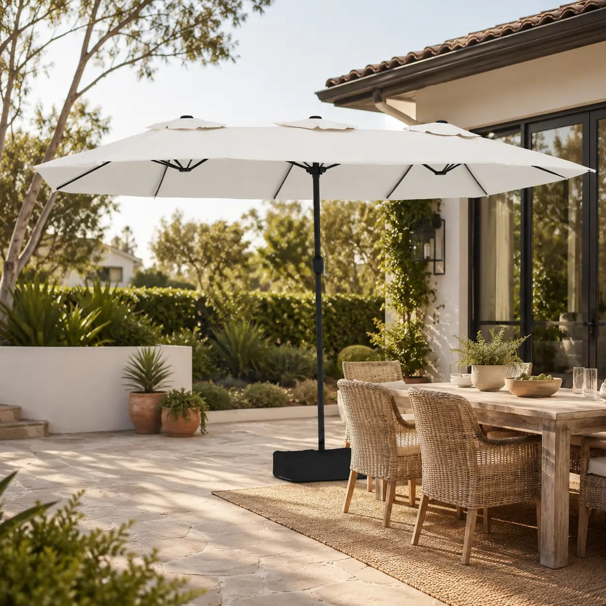 4.5m sand white double canopy market umbrella shading a wicker outdoor dining table in a garden alfresco setting