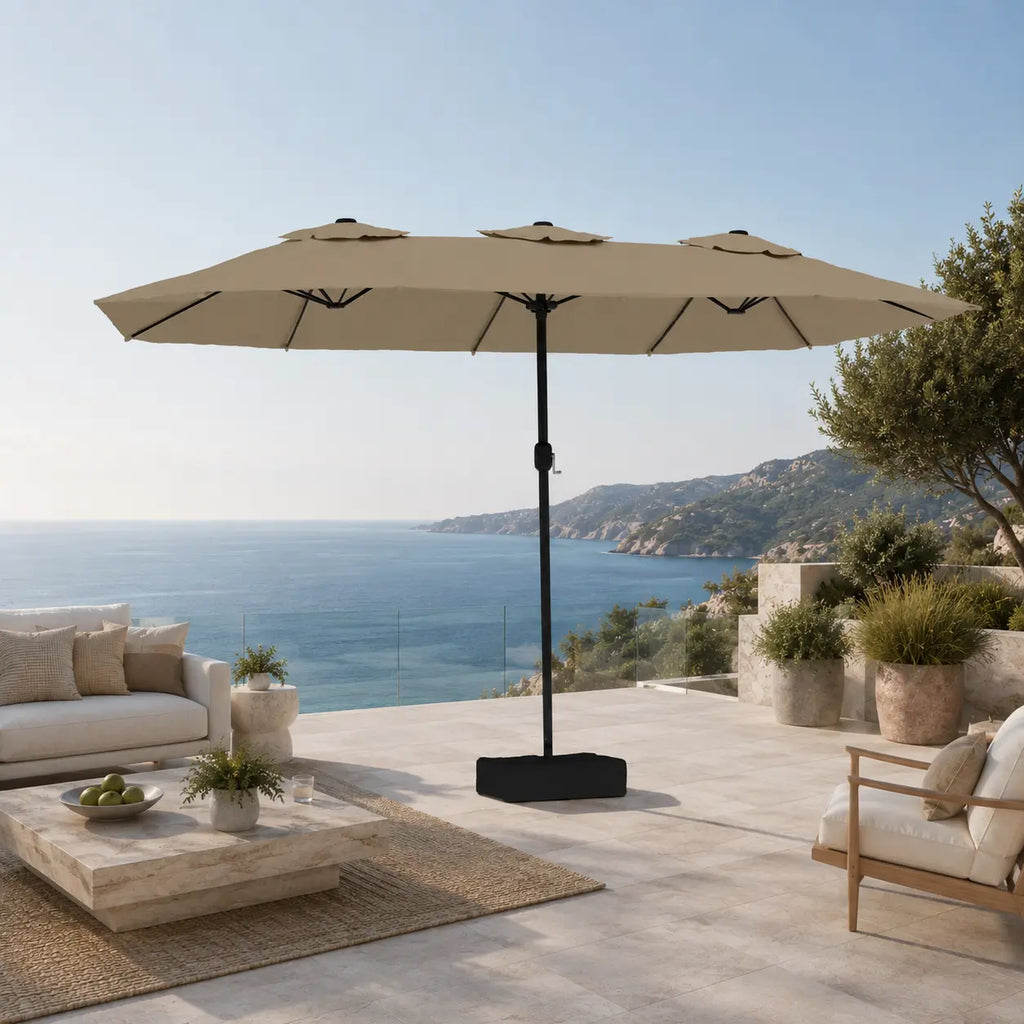 Large taupe double canopy market umbrella over timber outdoor lounge furniture on a coastal Australian terrace